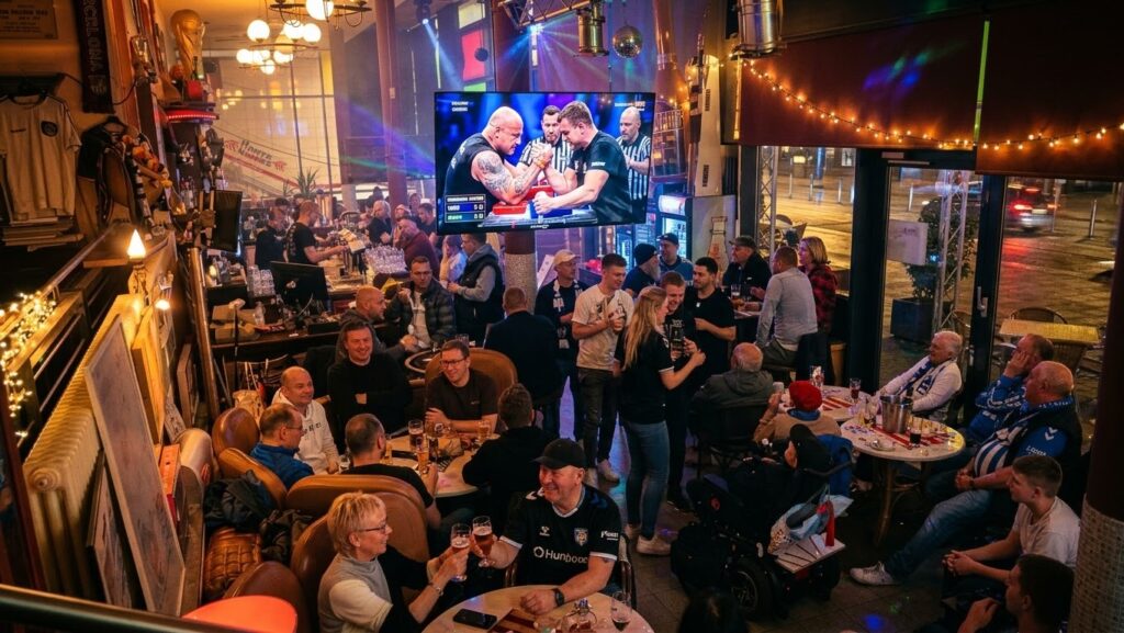 Armwrestling-Abend in einer vollen Sportsbar, auf dem Bildschirm läuft ein Armwrestling-Match